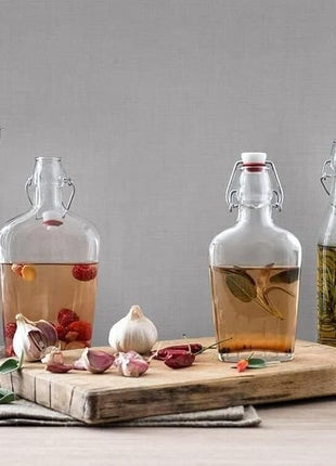 Bormioli Rocco Swing Top Glass Bottle (Set of 4) - 8.5 oz Reusable Container with Secure Metal Clasp, Ideal for Homemade Juices, Oil Infusions, Condiments, Mixers - Everyday Drinking Glasses